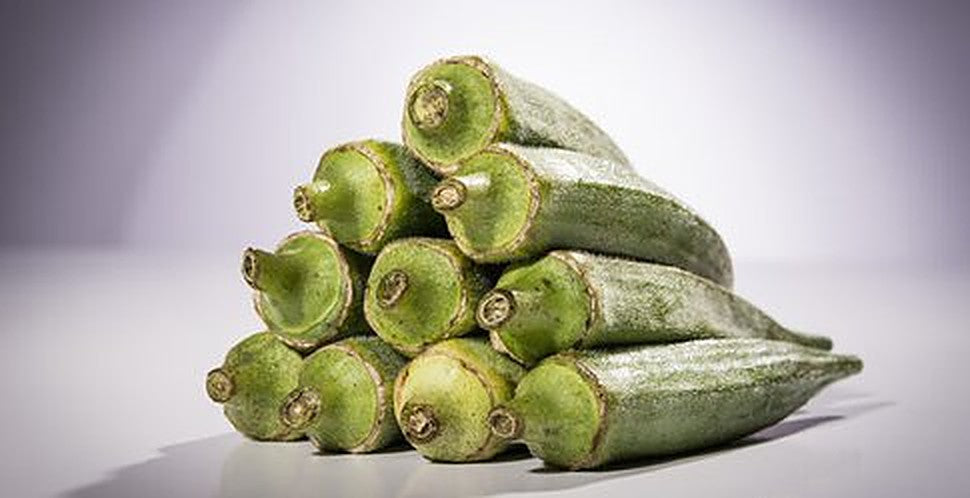 Smooth Green okra pods stacked after harvest, open-pollinated variety